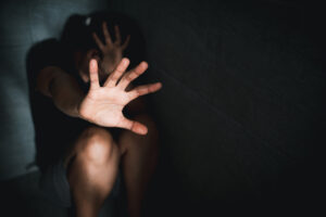 A hand reaching out through the darkness.