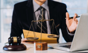 Solicitor at desk explaining how much compensation for e scooter accident claims someone could receive.